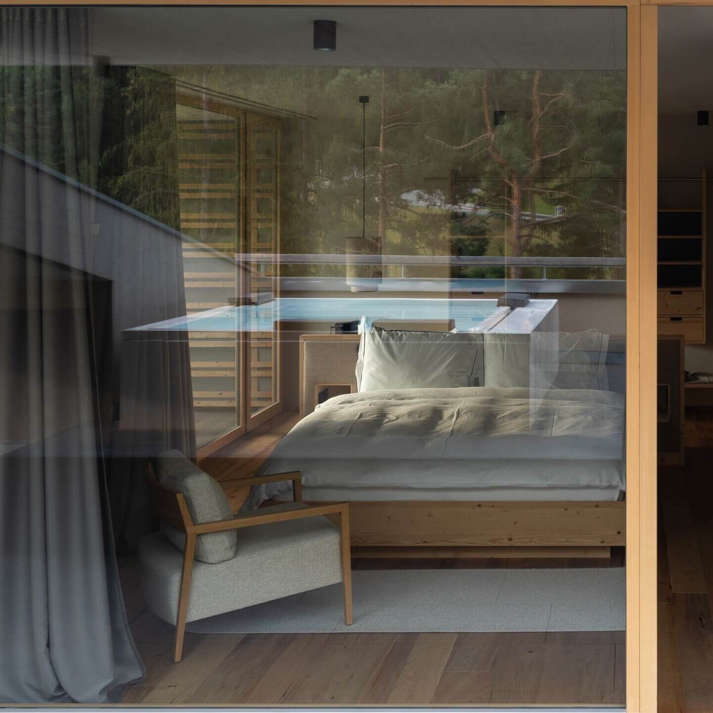 The view from outside a hotel room looking in at a solid timber bed frame and plush white bedding.